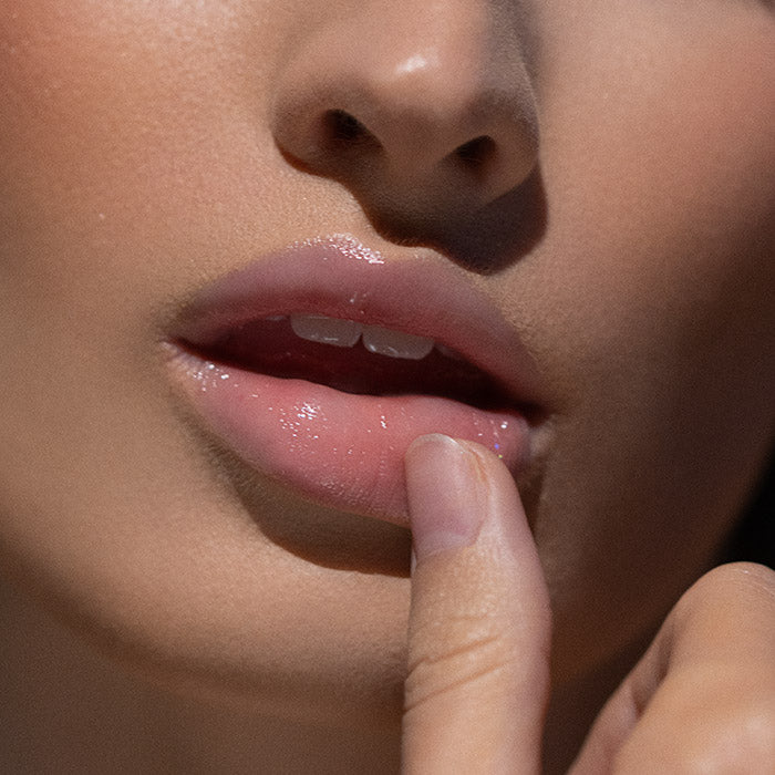 Błyszczyk do ust Hedonista Madam Glam Lipgloss – delikatny różowy odcień z eleganckim połyskiem na ustach modelki